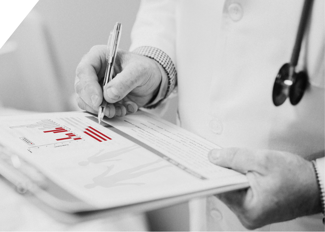 Black and white photo of a healthcare professional updating a medical chart.