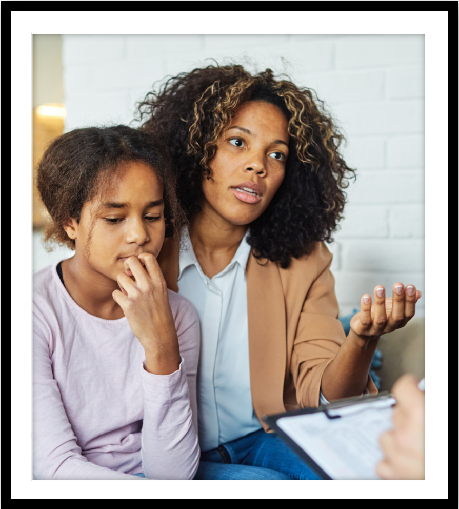 A woman and a young girl in a healthcare provider’s office.